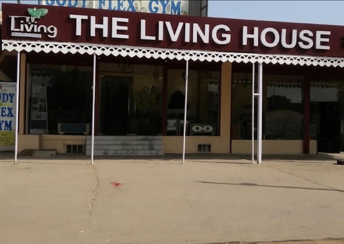  storefront with 'The Living House' sign on a clear day